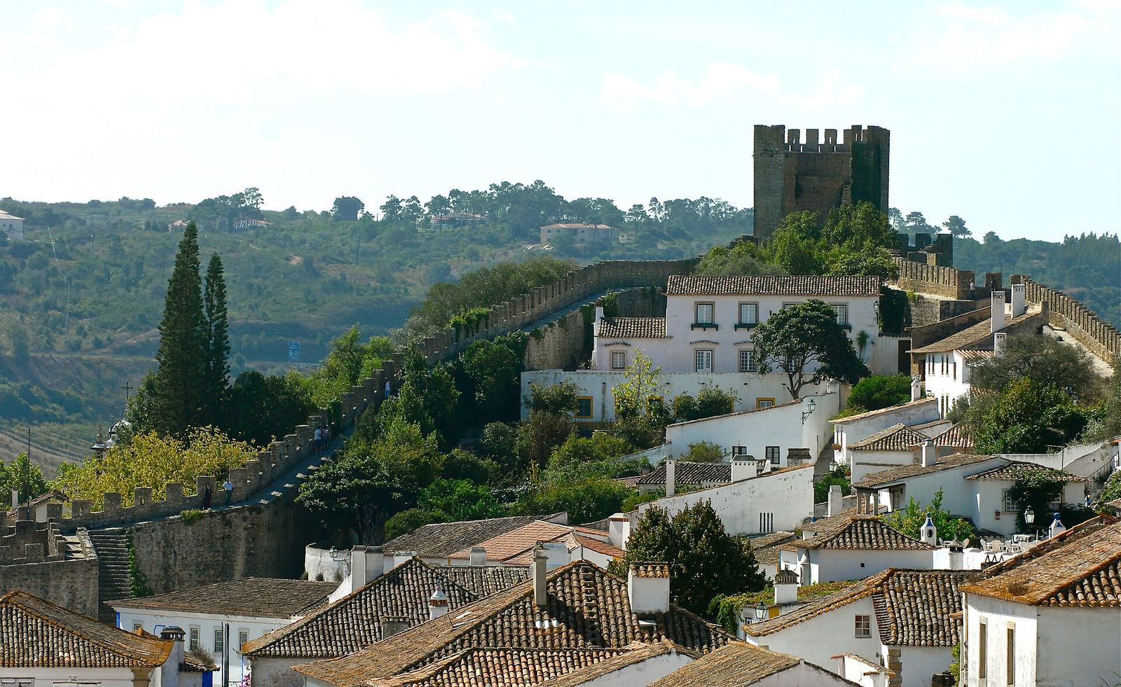 The castle and walls of Óbidos above whitewashed houses