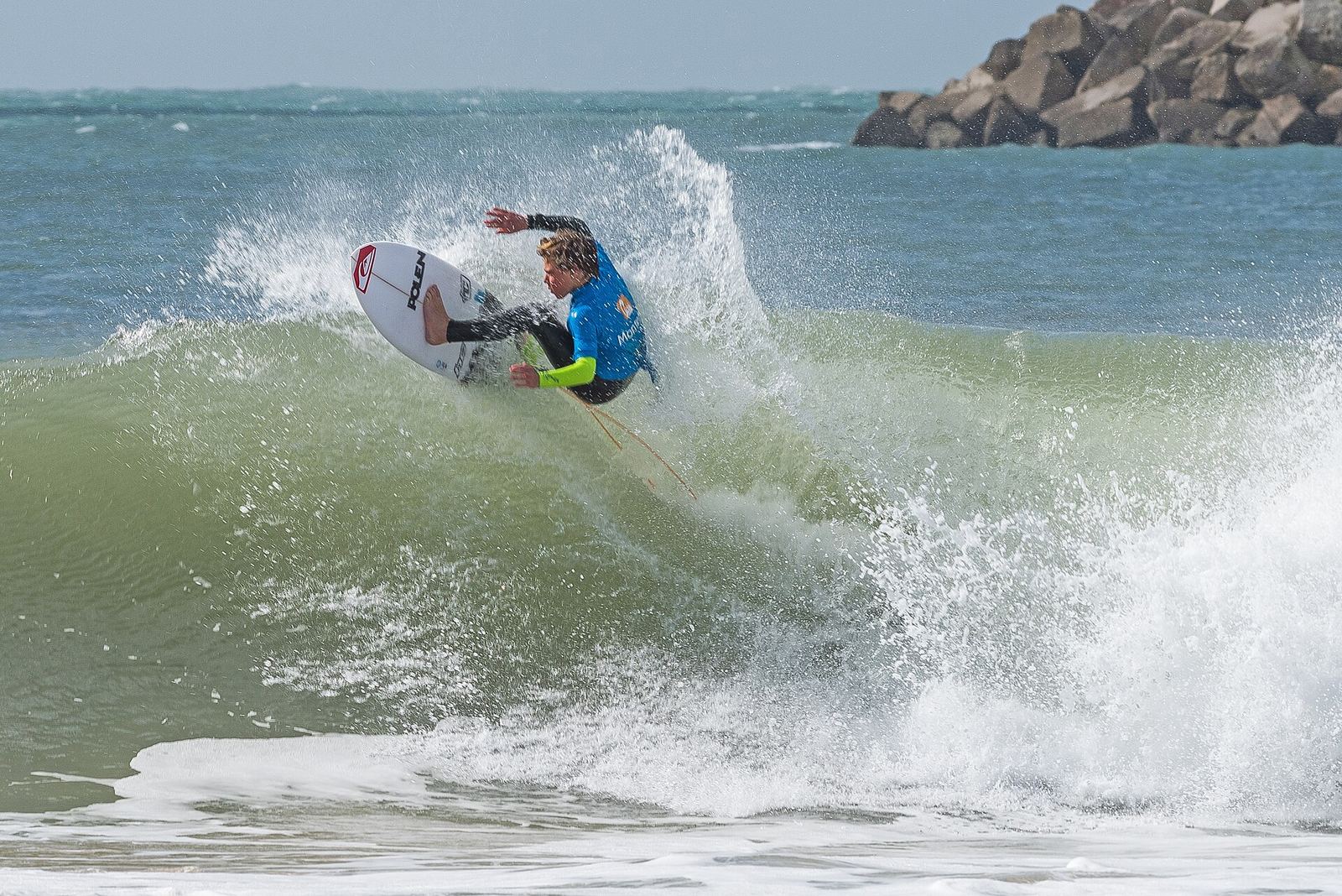 A surfer hitting the lip of a wave in Peniche