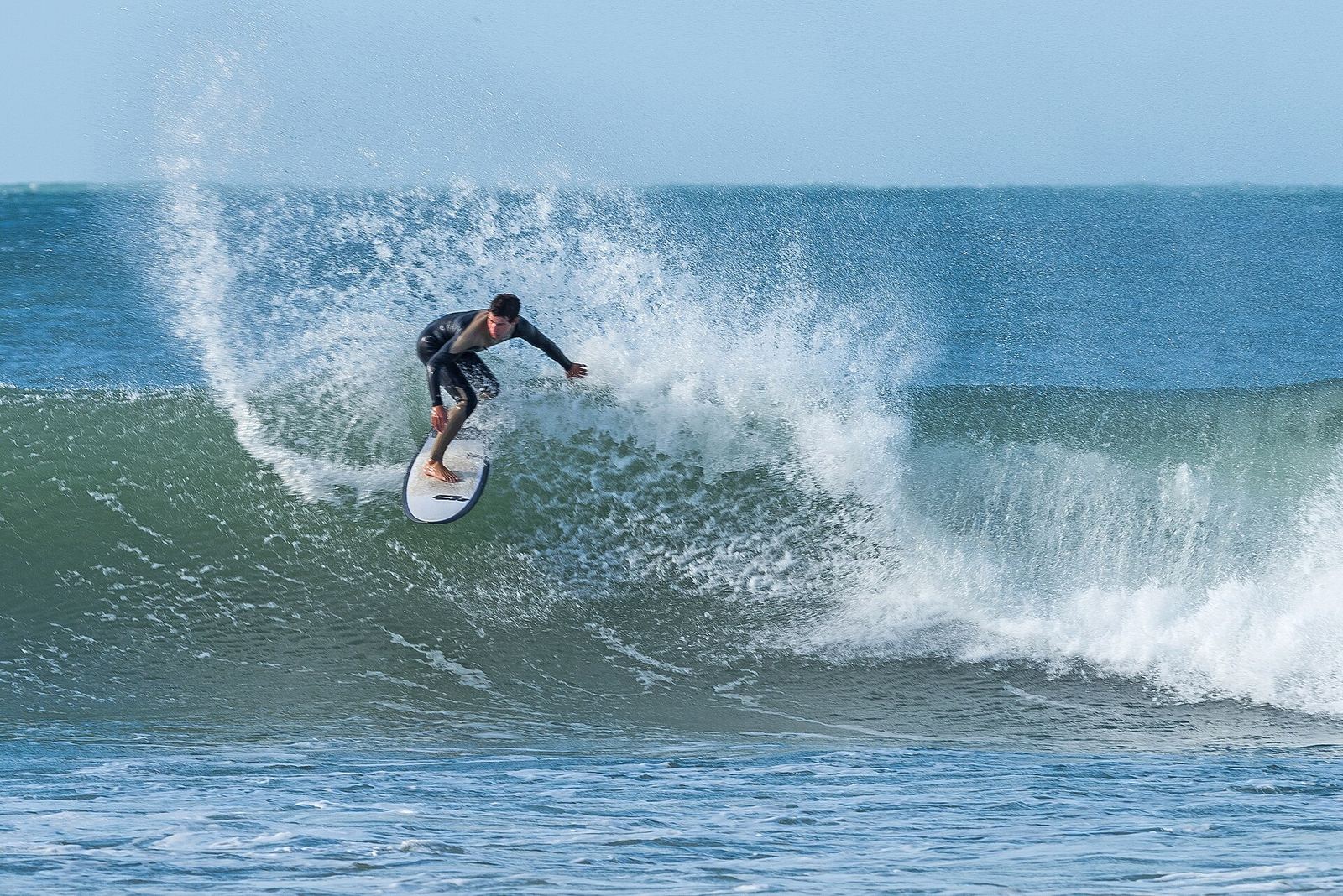 A surfer carving a wave in Peniche